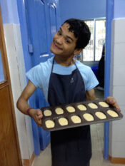 Shuktara Cakes - Ashok holding a tray of madeleine